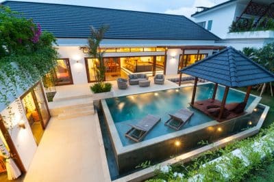 A contemporary house with a pool and outdoor seating area perfect for relaxation and entertainment - pool renovation